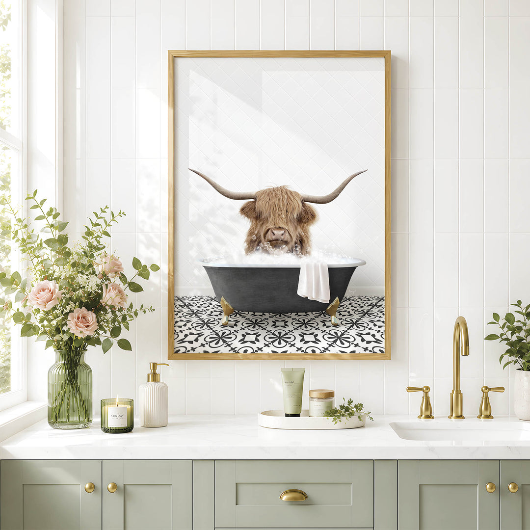 a bathroom with a framed picture of a Highland cow sitting in a bathtub, surrounded by flowers and candles.