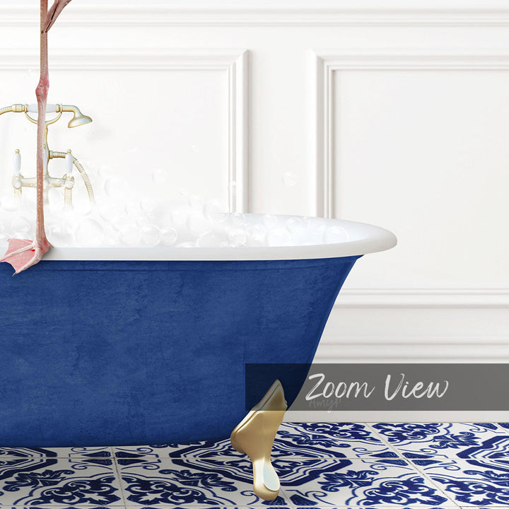 A blue claw-foot bathtub filled with water, set against a white wall with a patterned tile floor.