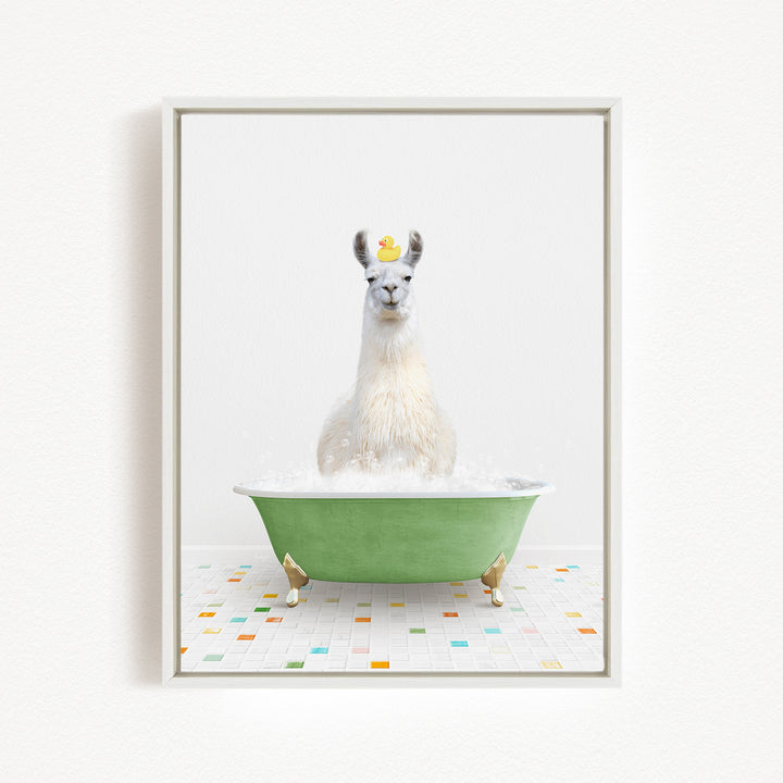 A white llama sitting in a green bathtub filled with bubbles, with a yellow rubber duck floating on its head.