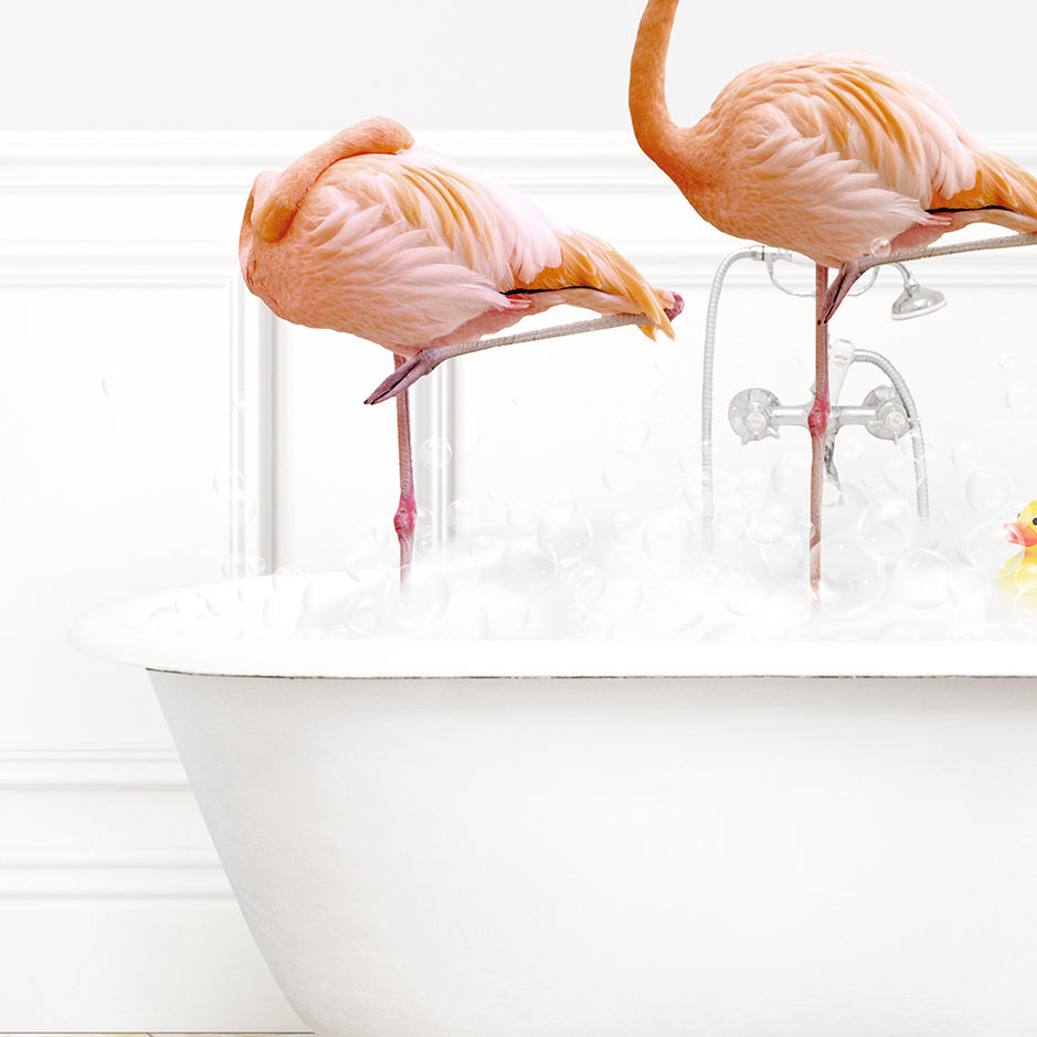 two pink flamingos standing in a bathtub with bubbles