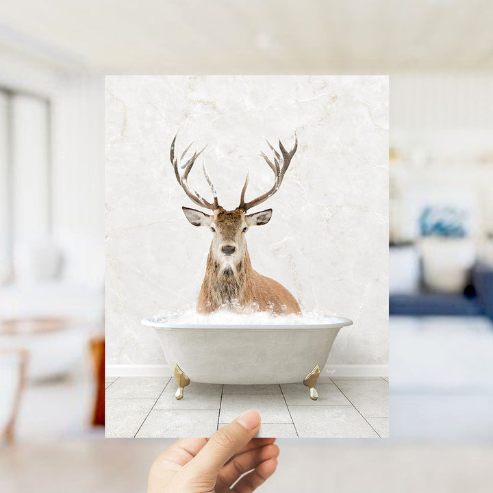 A deer with large antlers is sitting in a bathtub filled with water, creating a whimsical and unexpected scene.
