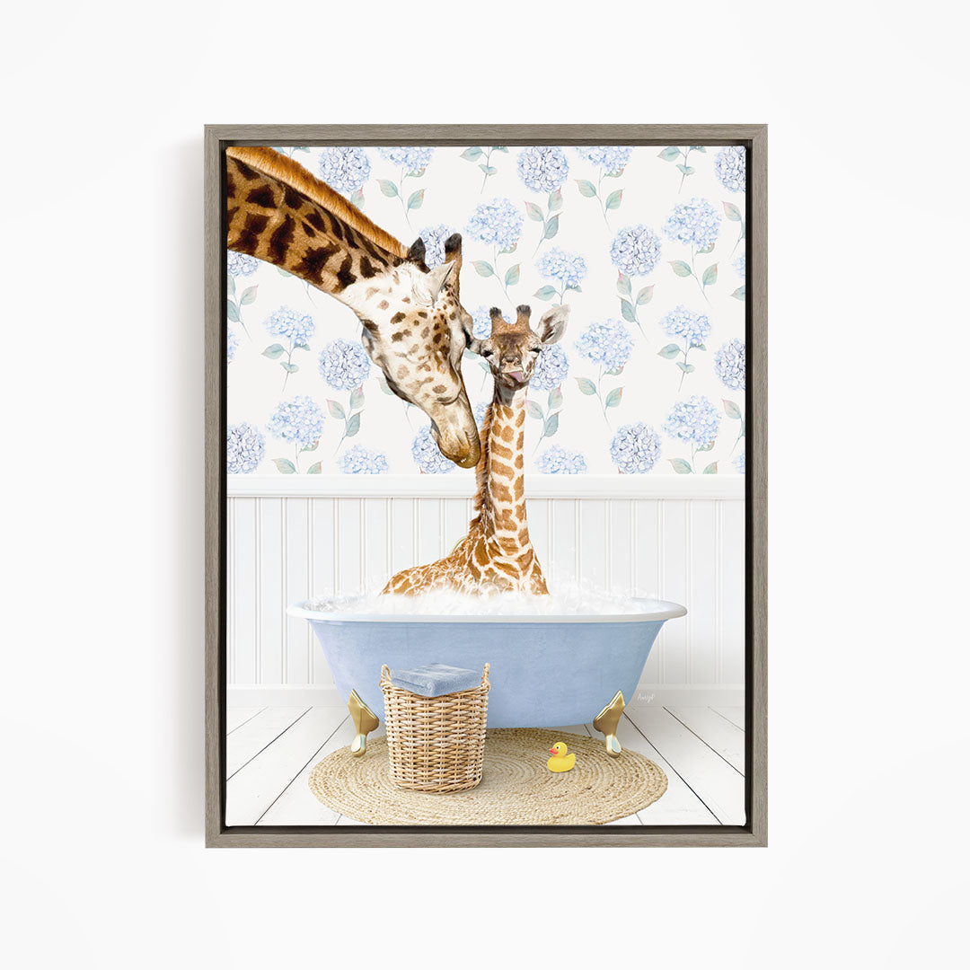 A giraffe and a baby giraffe are sitting in a blue bathtub, with a basket of rubber ducks nearby.