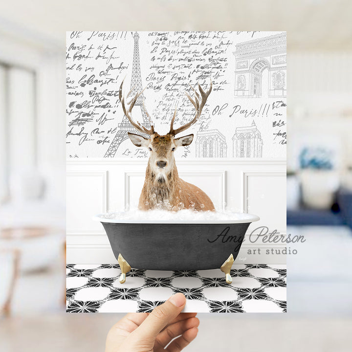 a person holding up a card with a picture of a deer in a bathtub