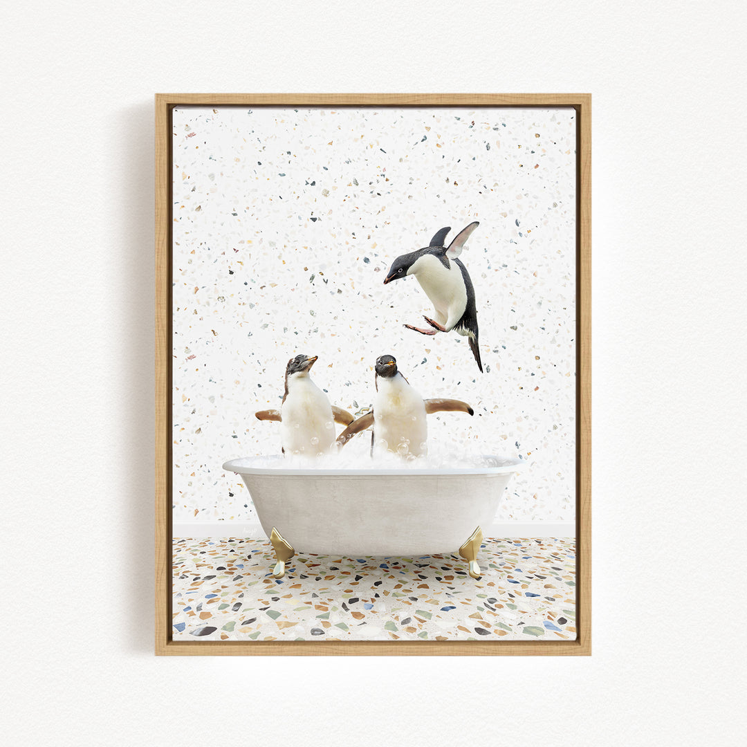 A framed image depicting two penguins sitting in a bathtub, with one penguin flying out of the tub.
