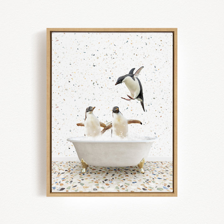 A framed image depicting two penguins sitting in a bathtub, with one penguin flying out of the tub.