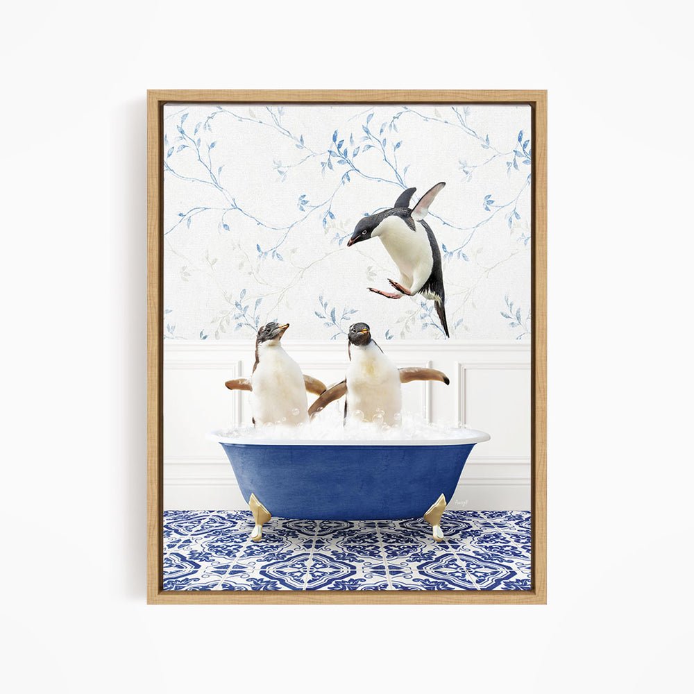 A framed image depicting two penguins sitting in a blue bathtub, with one penguin flying towards the other in mid-air.