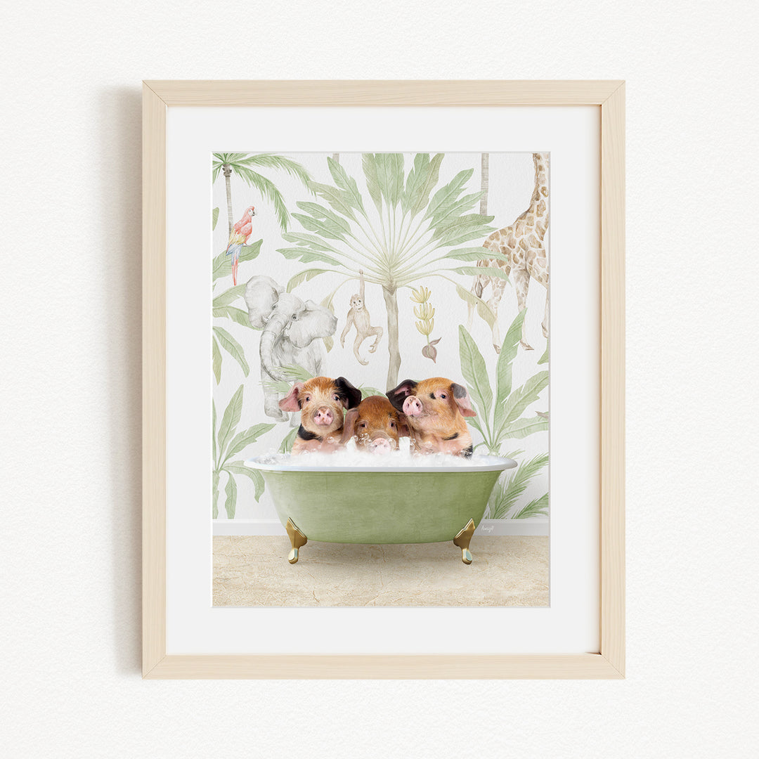 A framed print depicting three pigs sitting in a green bathtub, surrounded by a tropical jungle wallpaper.