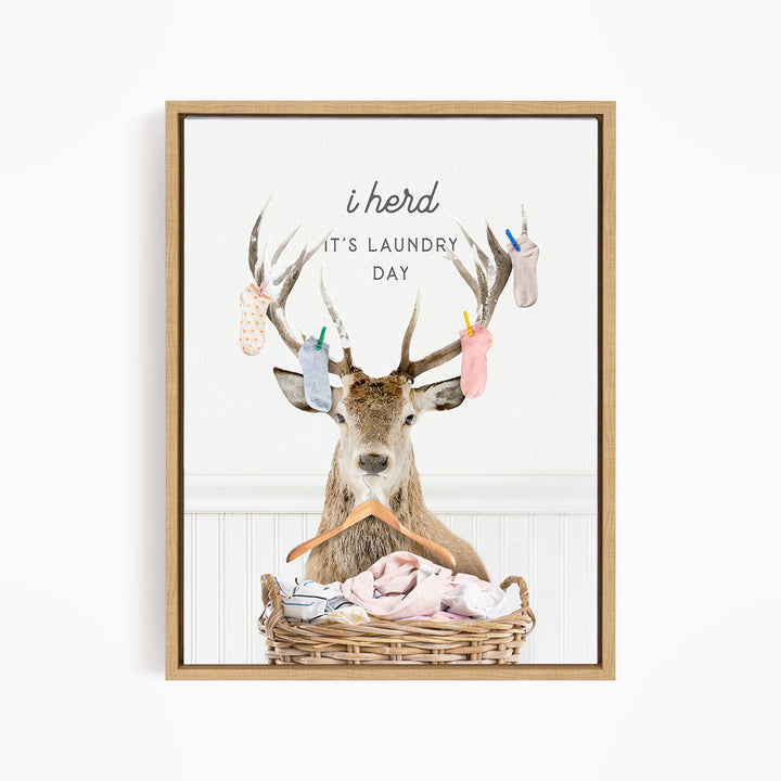 A deer with antlers holding laundry in a basket, with the text "I herd, it's laundry day" displayed above the deer.