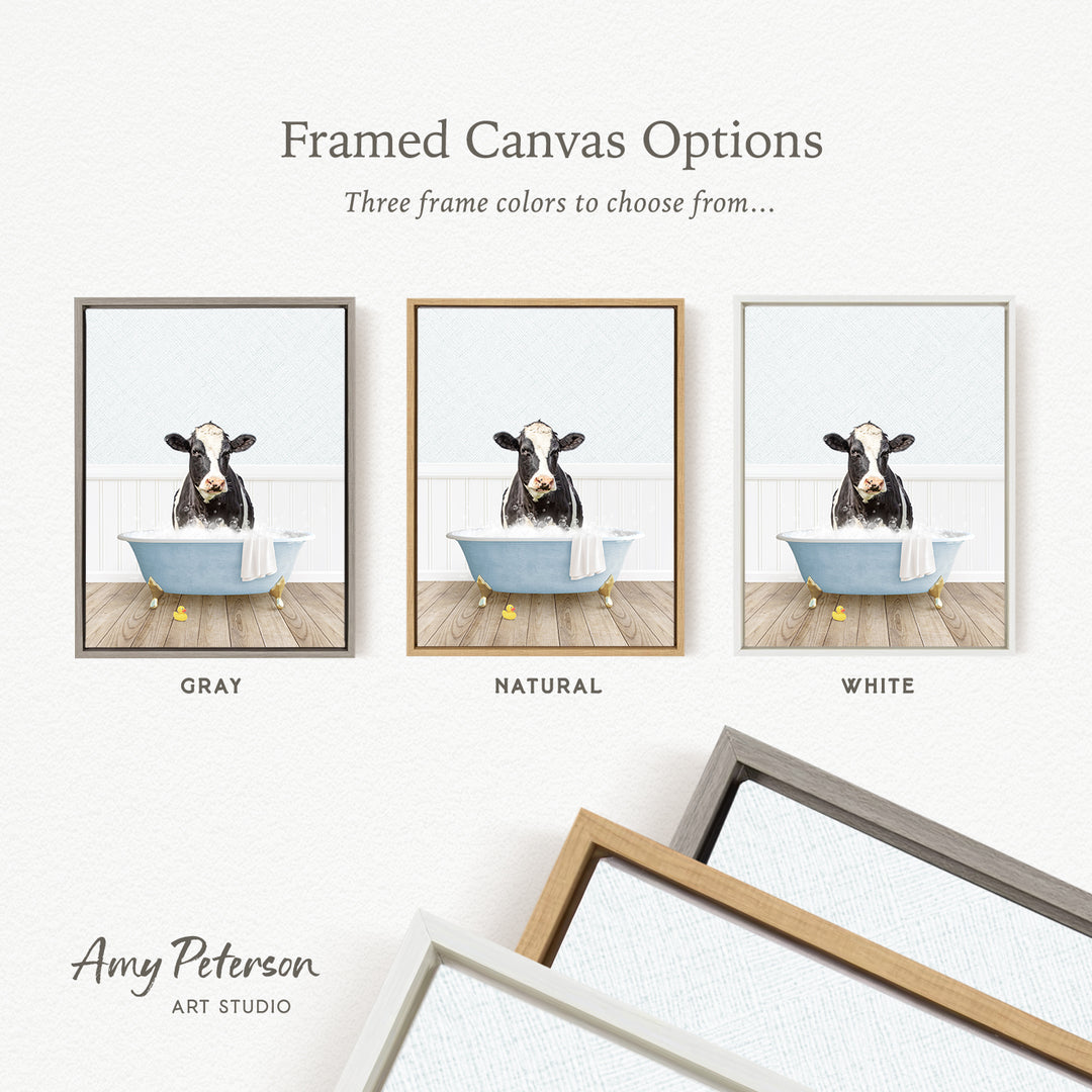 The image is a framed canvas option featuring a cow sitting in a bathtub, with three different frame colors to choose from: gray, natural, and white.
