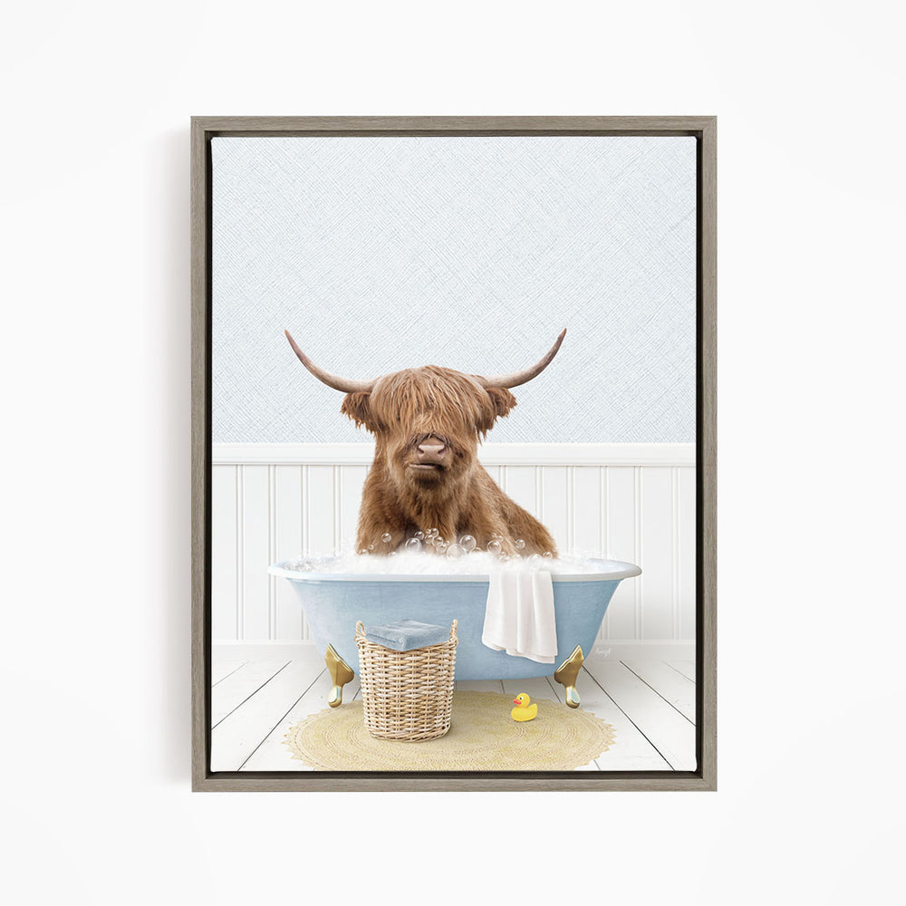 A brown cow with long horns is sitting in a blue bathtub filled with water, surrounded by rubber ducks.