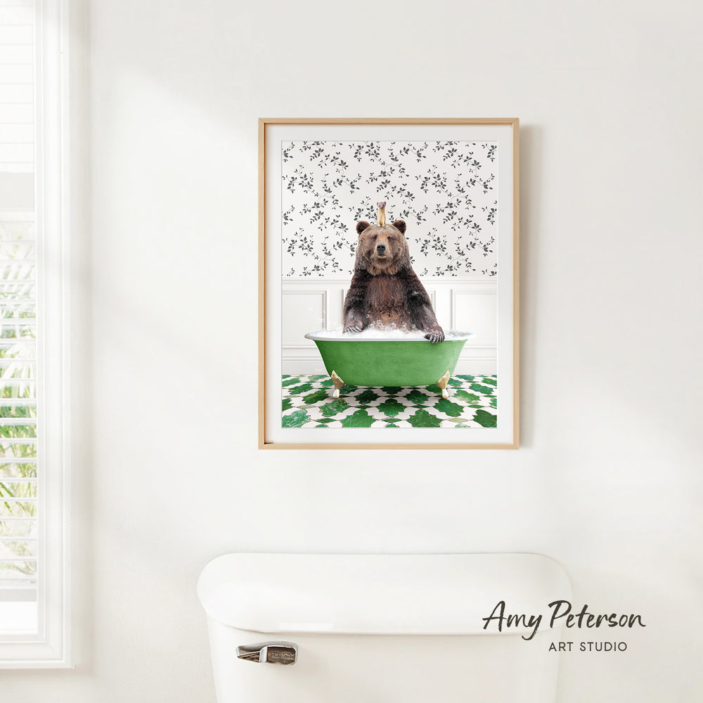 A framed image of a bear sitting in a green bathtub, with a patterned wall behind it.