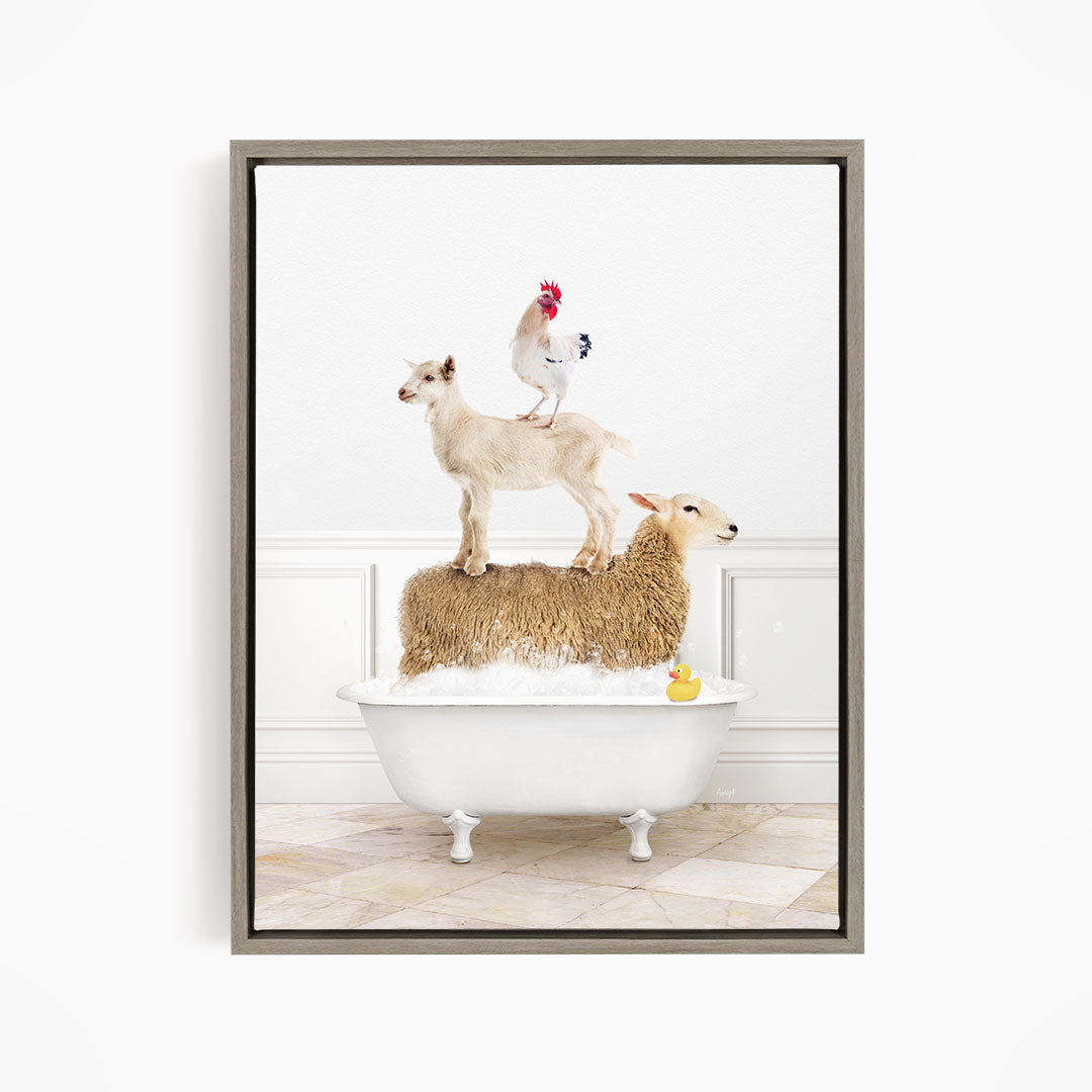 A framed image depicting a sheep standing on a goat's back, with a rooster perched on top of the goat, and a lamb standing in a bathtub filled with water and a rubber duck.