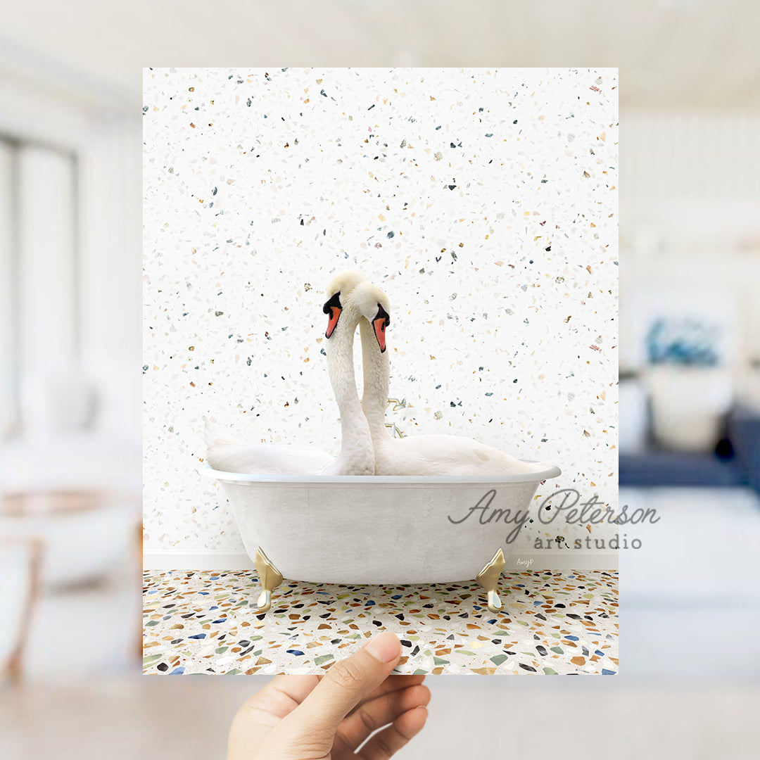 a person holding up a picture of a swan in a bathtub