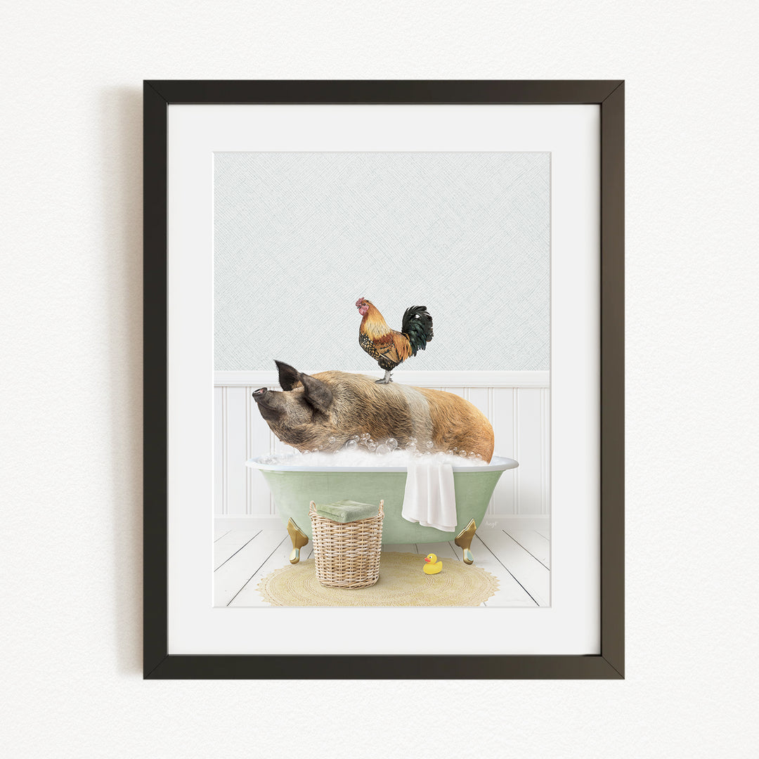 A framed image depicting a pig sitting in a bathtub, with a rooster perched on its back, and a basket of rubber ducks nearby.