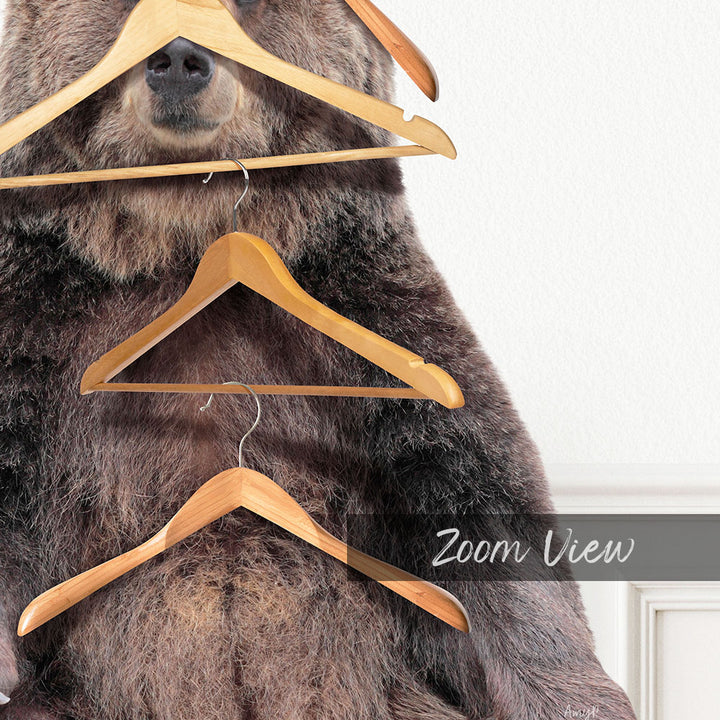 A close-up of a bear's face with wooden hangers hanging from its mouth and nose.