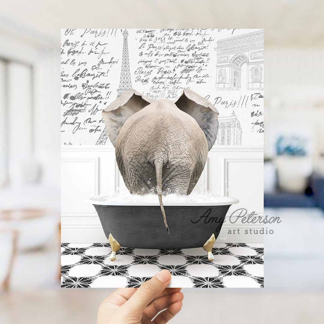 a person holding up a card with an elephant in a bathtub