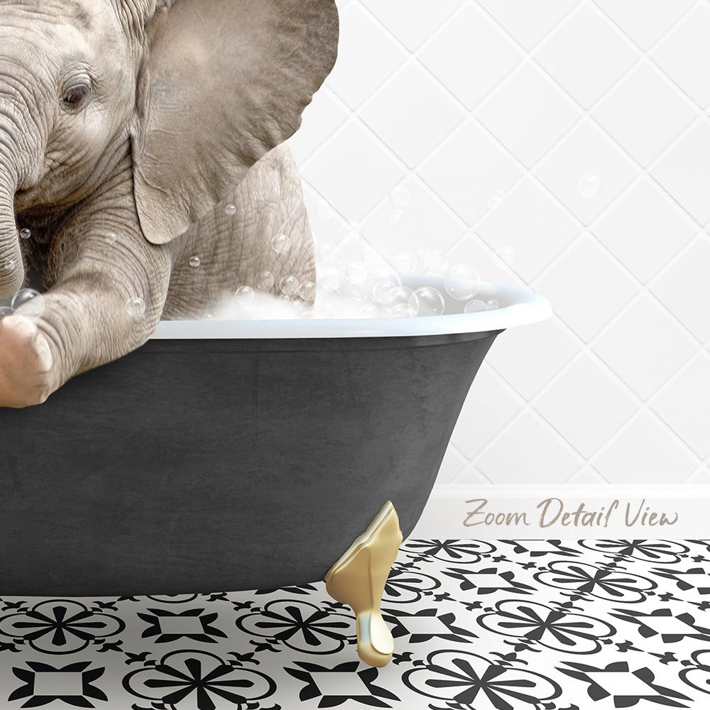 A baby elephant sitting in a bathtub filled with bubbles, surrounded by a black and white patterned floor.