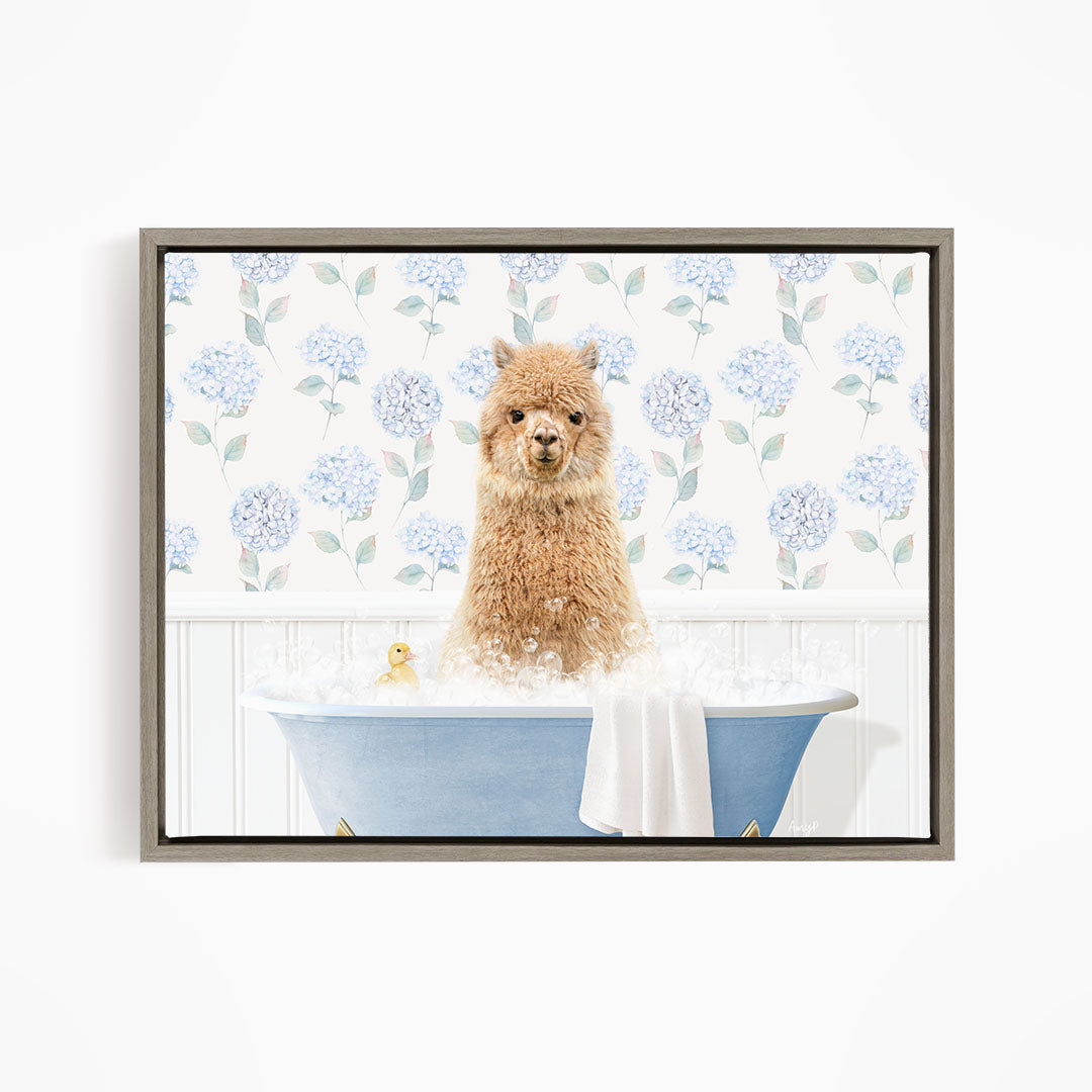 A fluffy brown alpaca sitting in a blue bathtub filled with bubbles, surrounded by a floral patterned wall.