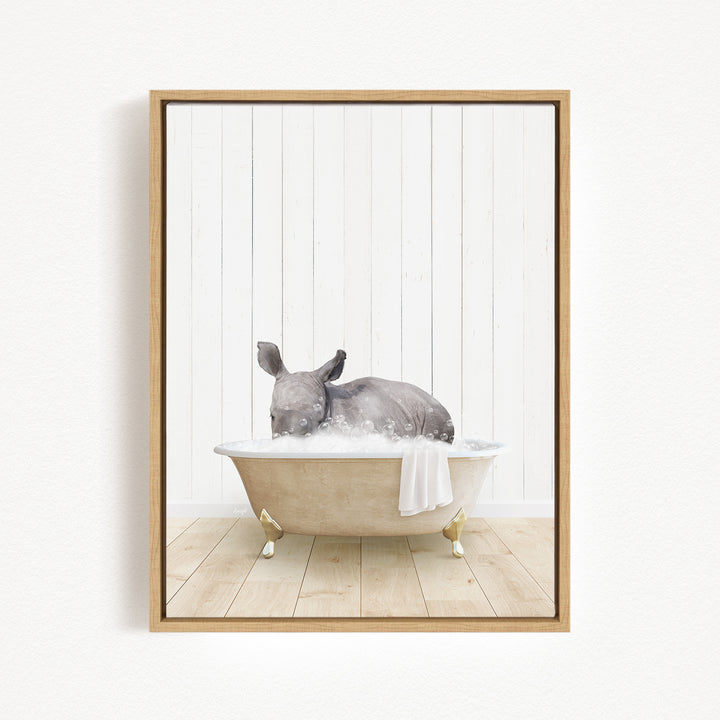 A gray rabbit is sitting in a bathtub filled with water, surrounded by a white wooden wall.