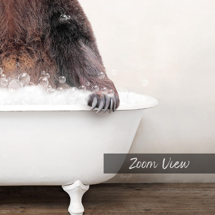 A close-up of a bear's paw resting on the edge of a white bathtub filled with bubbles, with the text "Zoom View" overlaid on the image.