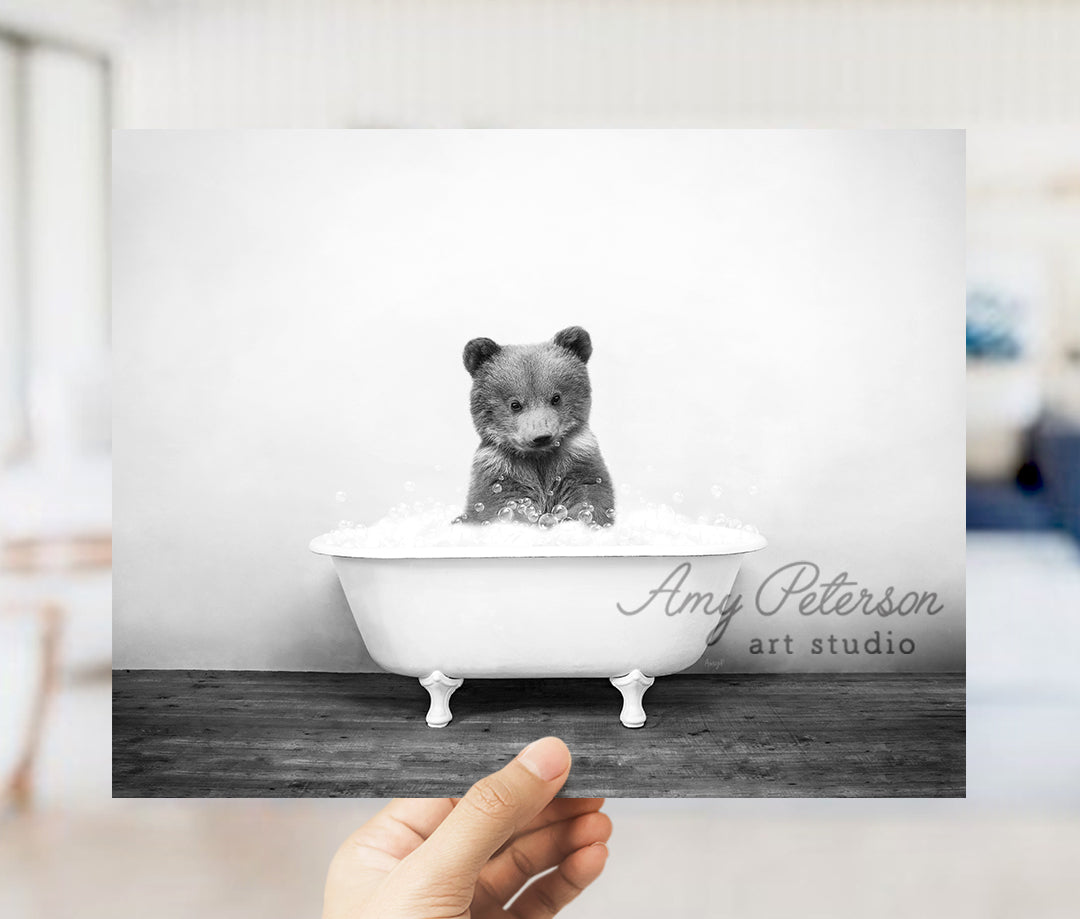 a black and white photo of a bear in a bathtub