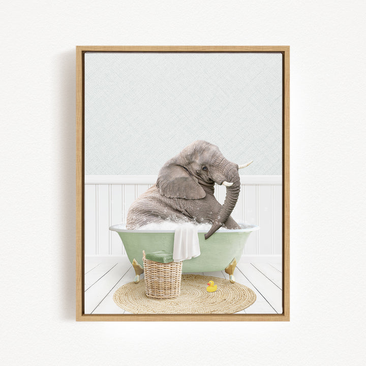 A gray elephant is sitting in a green bathtub, surrounded by a basket of toys and a yellow rubber duck, creating a whimsical and playful scene.