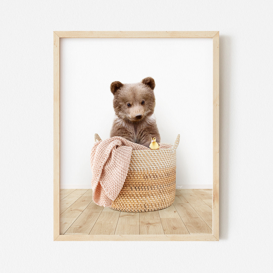 a brown teddy bear sitting in a basket