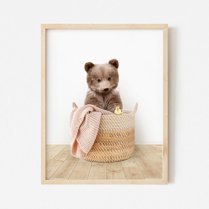 a brown teddy bear sitting in a basket