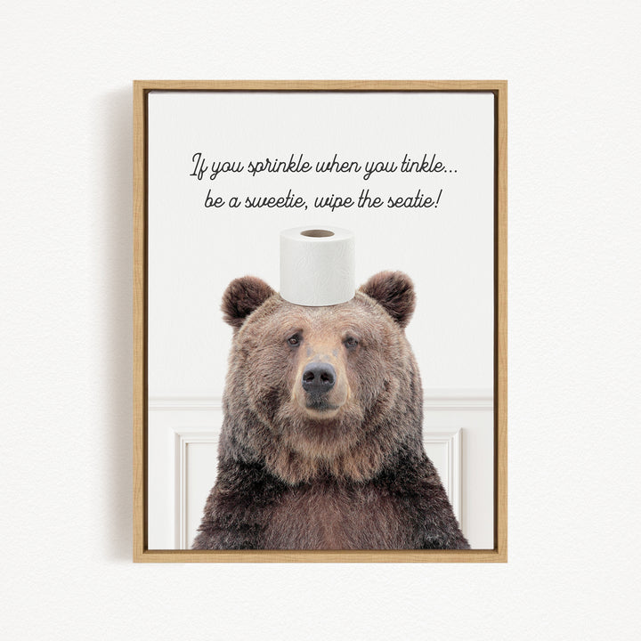 A brown bear sitting on a roll of toilet paper with a humorous caption above it.