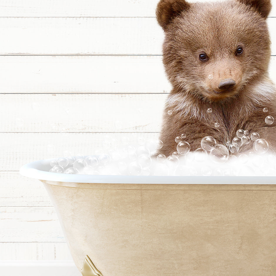 a brown bear sitting inside of a bath tub filled with bubbles