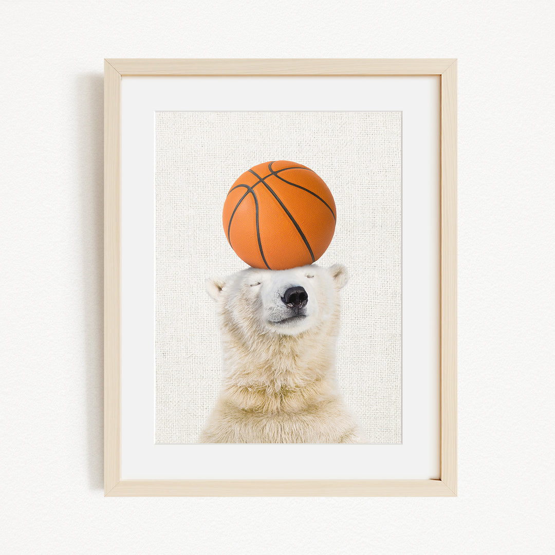 A polar bear balancing a basketball on its head.