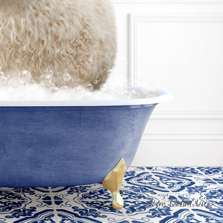 A fluffy white dog is standing in a blue bathtub filled with bubbles, with a gold bathtub spout visible.