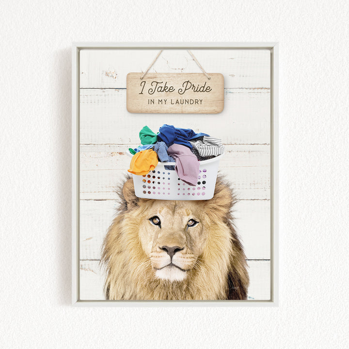 A framed image of a lion with a basket of laundry on its head, accompanied by a wooden sign that reads "I Take Pride in my Laundry".