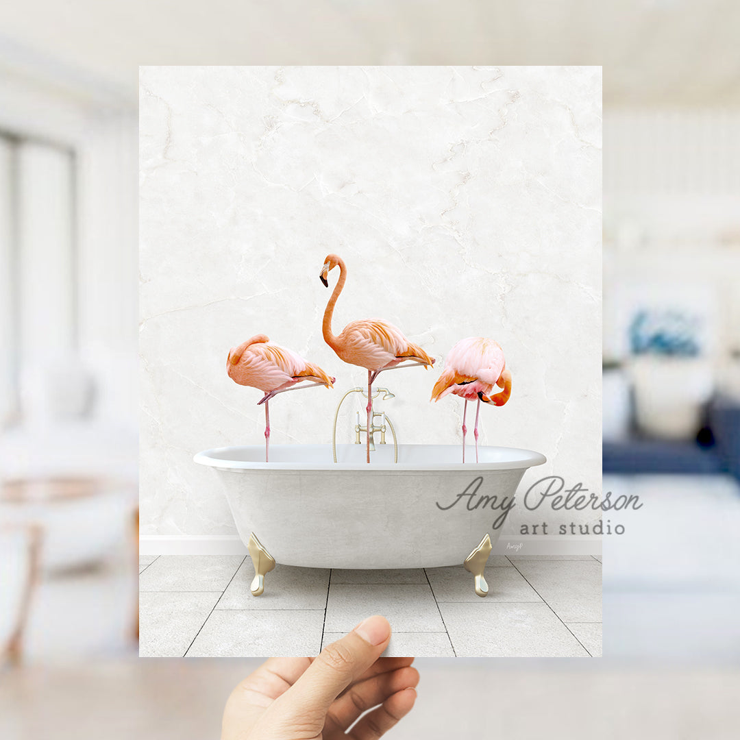 a person holding a photo of three flamingos in a bathtub