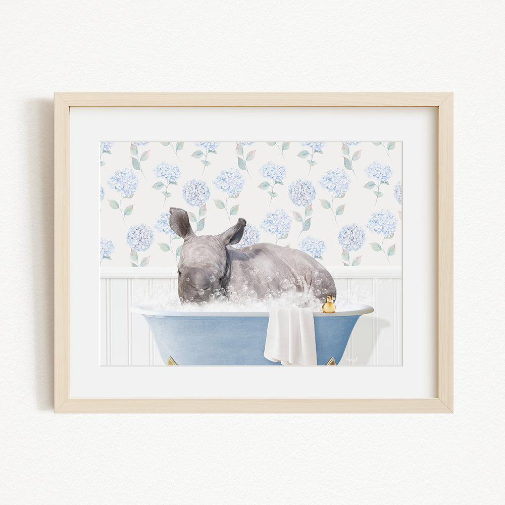 A rhinoceros is sitting in a blue bathtub filled with water, surrounded by a floral pattern on the wall behind it.