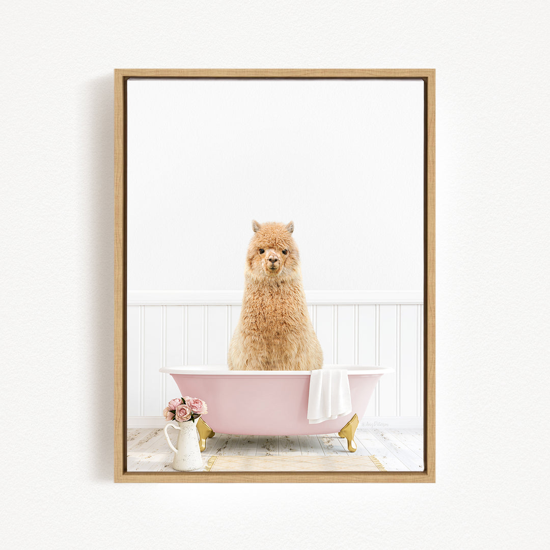 A fluffy alpaca sits in a pink bathtub, surrounded by a white towel and a vase of flowers, creating a whimsical and charming scene.