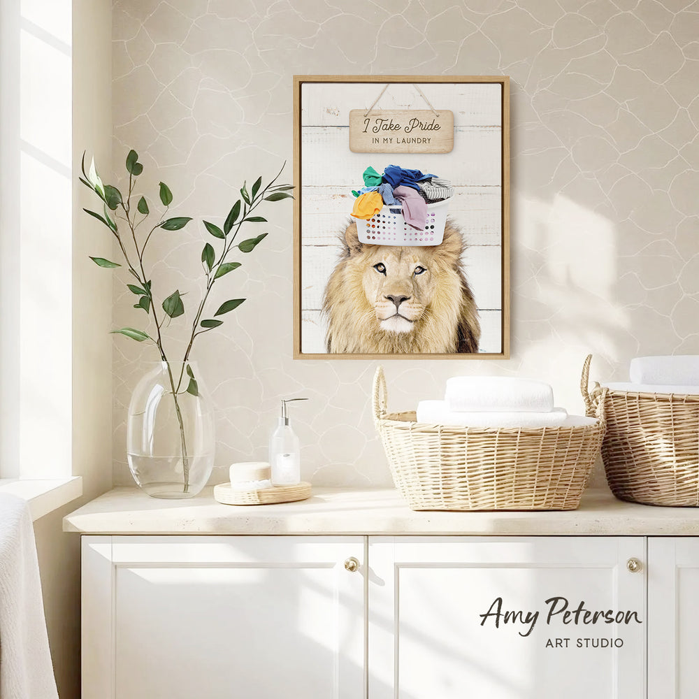 a framed picture of a lion wearing a laundry basket hat, hanging on a wall above a white cabinet with baskets.