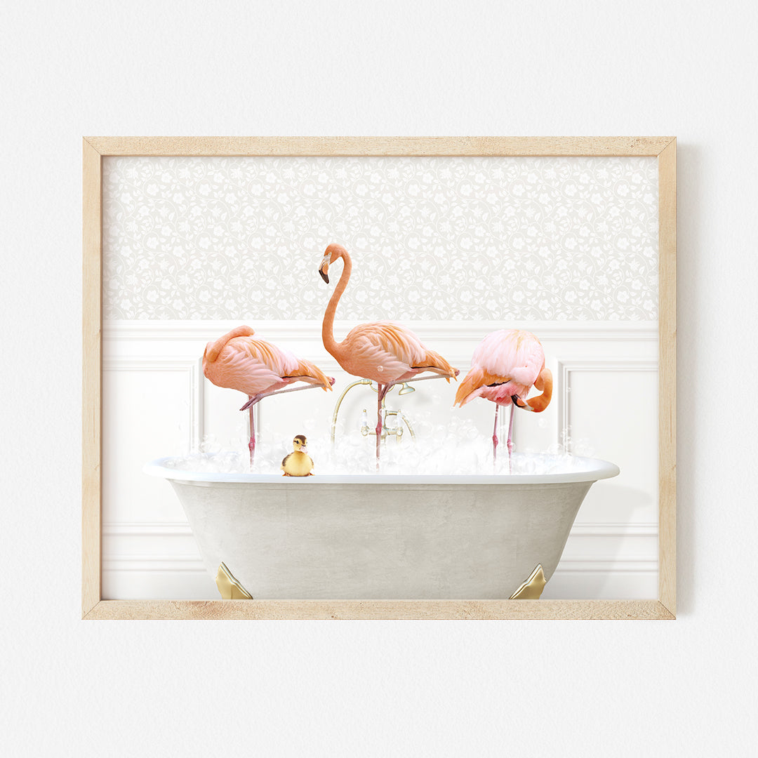 three pink flamingos in a bathtub with bubbles