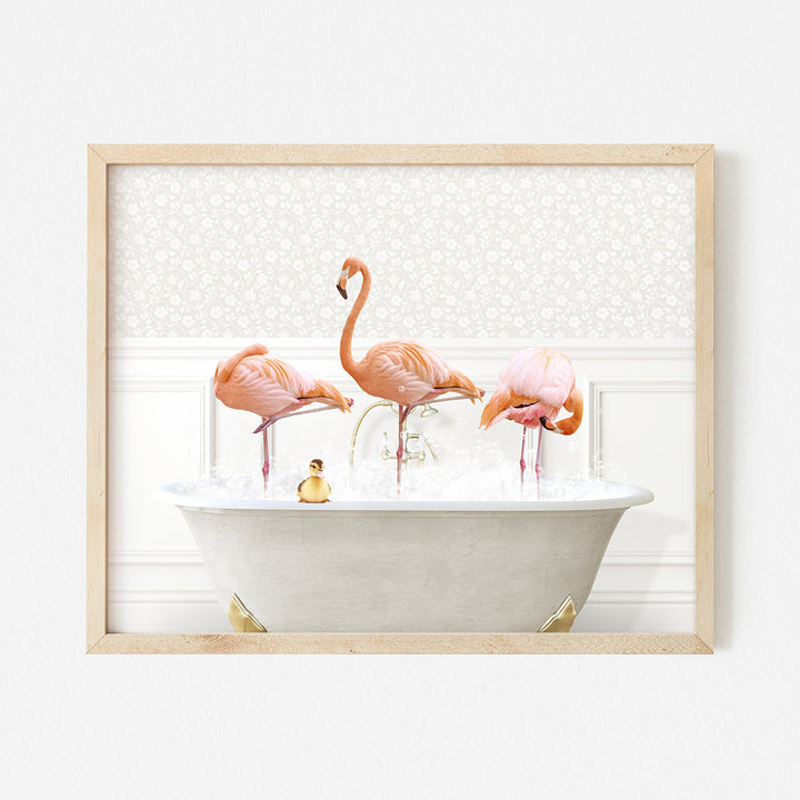 three pink flamingos in a bathtub with bubbles