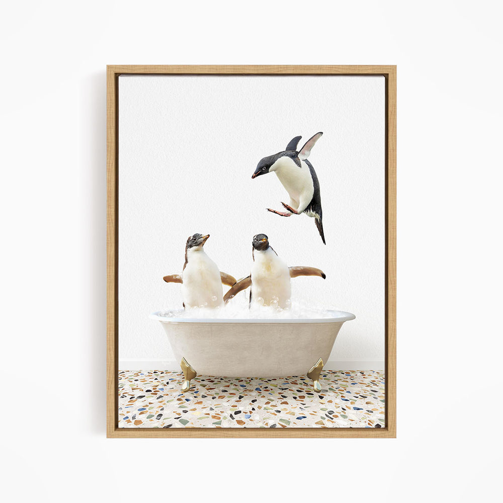 A framed image depicting two penguins standing in a bathtub filled with water, with one penguin flying towards the other.