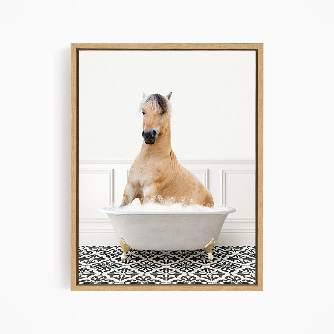 A light brown horse is sitting in a white bathtub filled with water, surrounded by a black and white patterned floor.