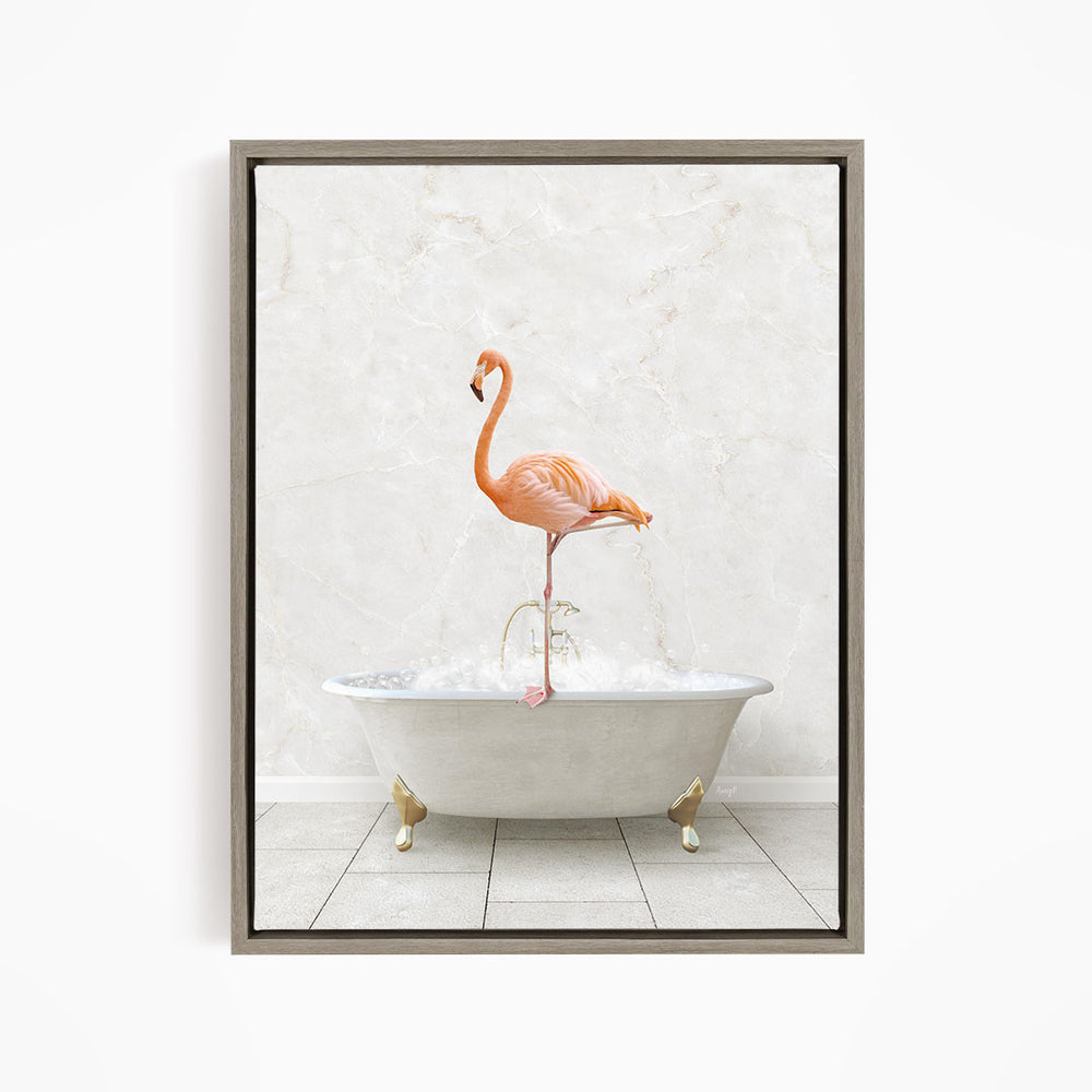 A pink flamingo standing on the edge of a white bathtub filled with bubbles.
