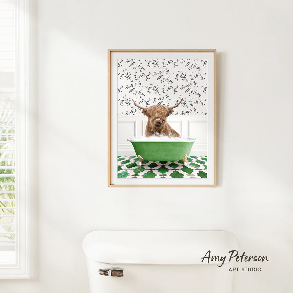 A framed print of a brown cow sitting in a green bathtub, with a patterned wall behind it.