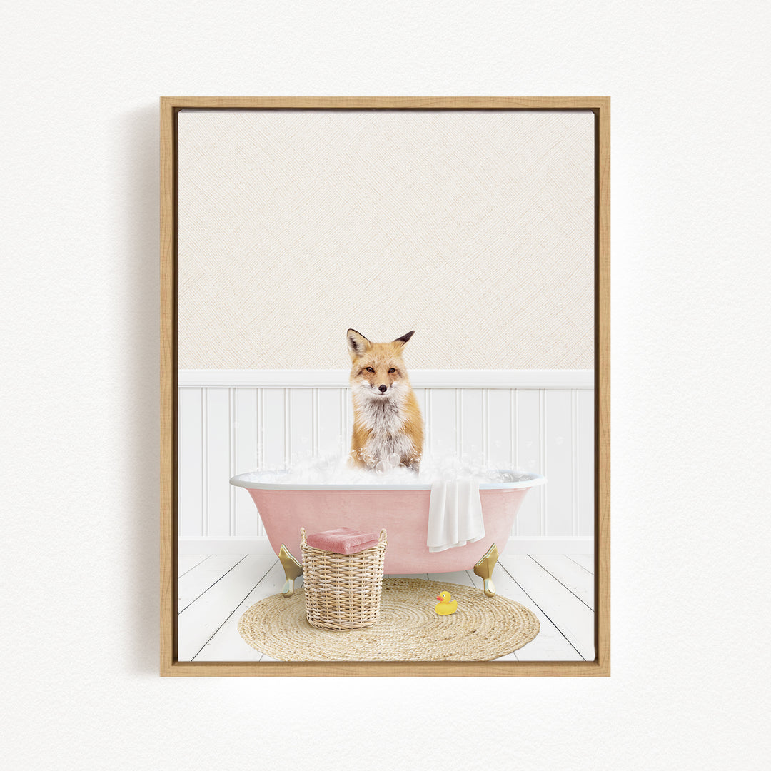 A fox is sitting in a pink bathtub filled with bubbles, surrounded by a basket of toys and a yellow rubber duck.