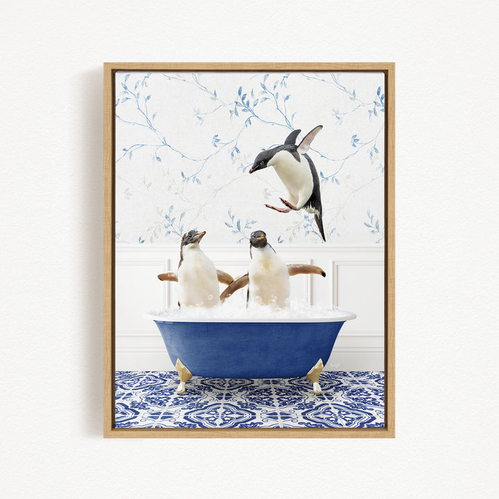 A framed image depicting two penguins sitting in a blue bathtub, with one penguin flying towards the other penguin.