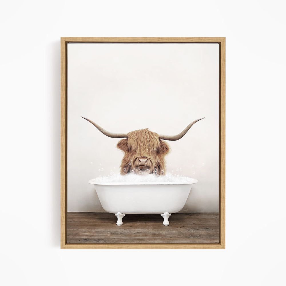 A Highland cow with long horns is sitting in a white bathtub filled with water, creating a whimsical and playful scene.
