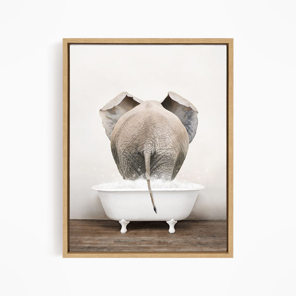 A gray elephant is standing in a white bathtub filled with water, with its trunk submerged in the water.