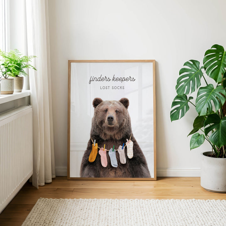 a large poster of a bear wearing a variety of colorful socks hanging from a clothesline.
