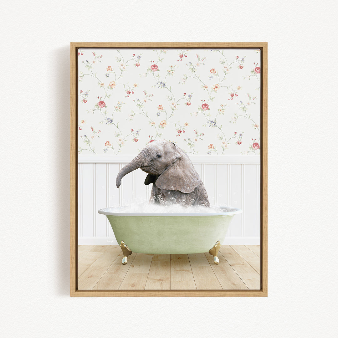 A baby elephant sitting in a green bathtub filled with water, surrounded by a floral wallpaper.