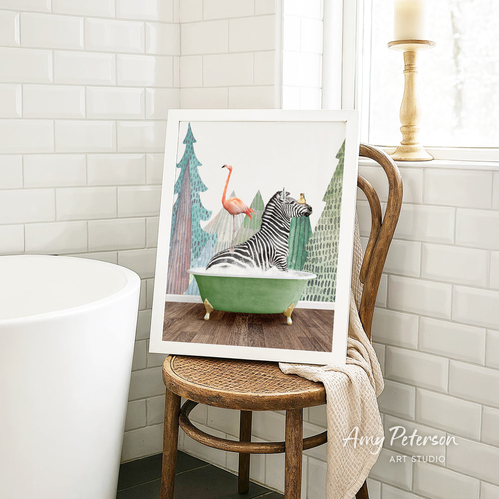 A framed painting of a zebra sitting in a green bathtub, surrounded by a pink flamingo and a tree, is displayed on a wooden chair in a bathroom setting.